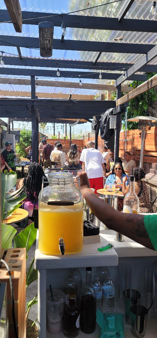 Guests enjoying an outdoor event near the cocktail bar
